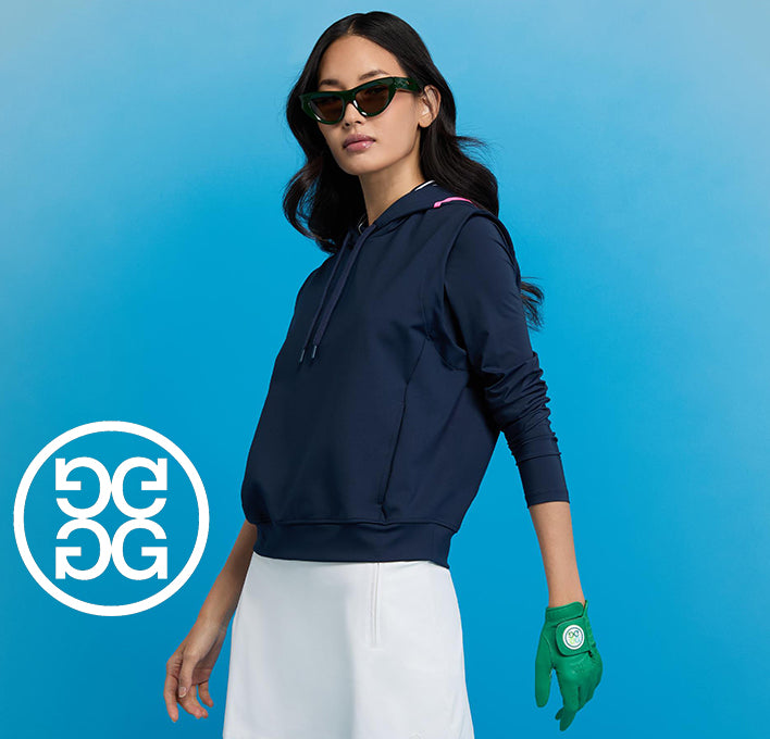 Woman modeling G/FORE womens golf clothes against a bold blue background