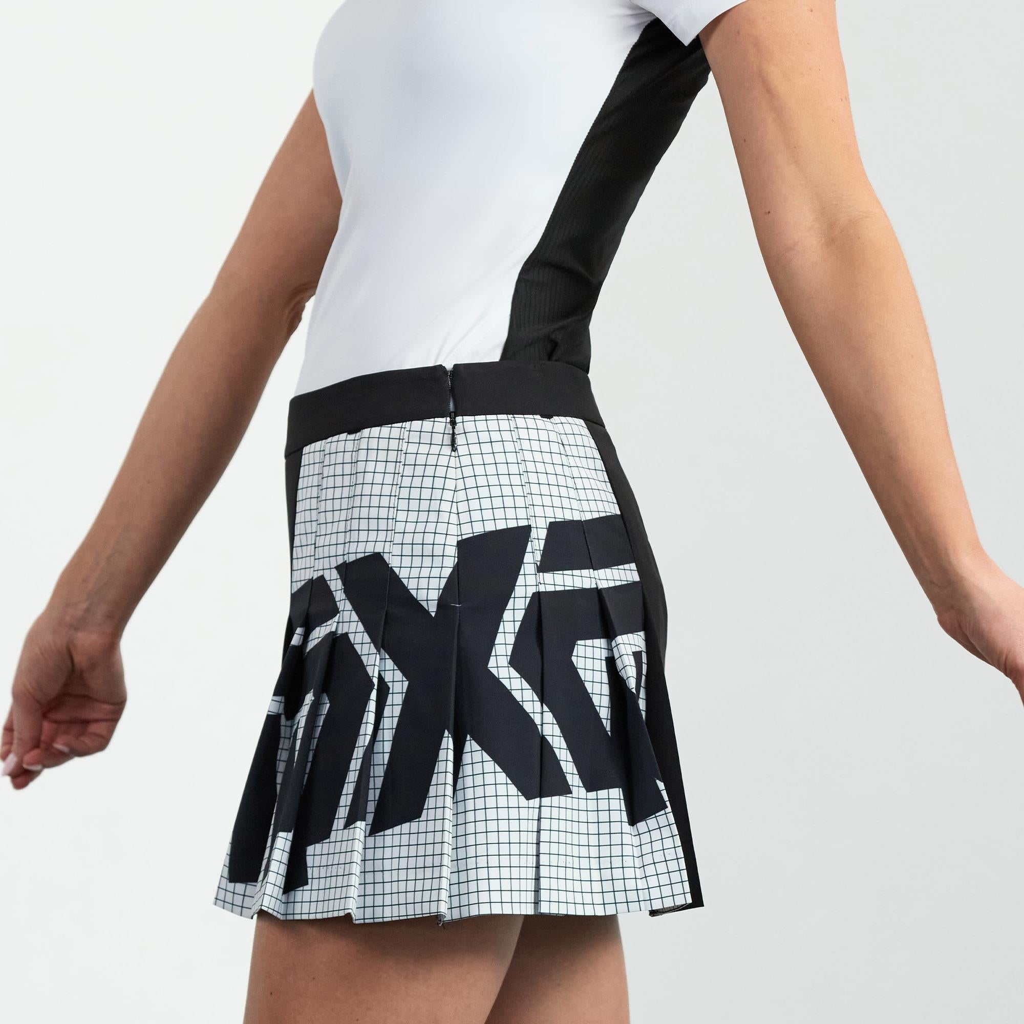 Model Wearing PXG Big Logo Pleated Golf Skirt in Black – Side