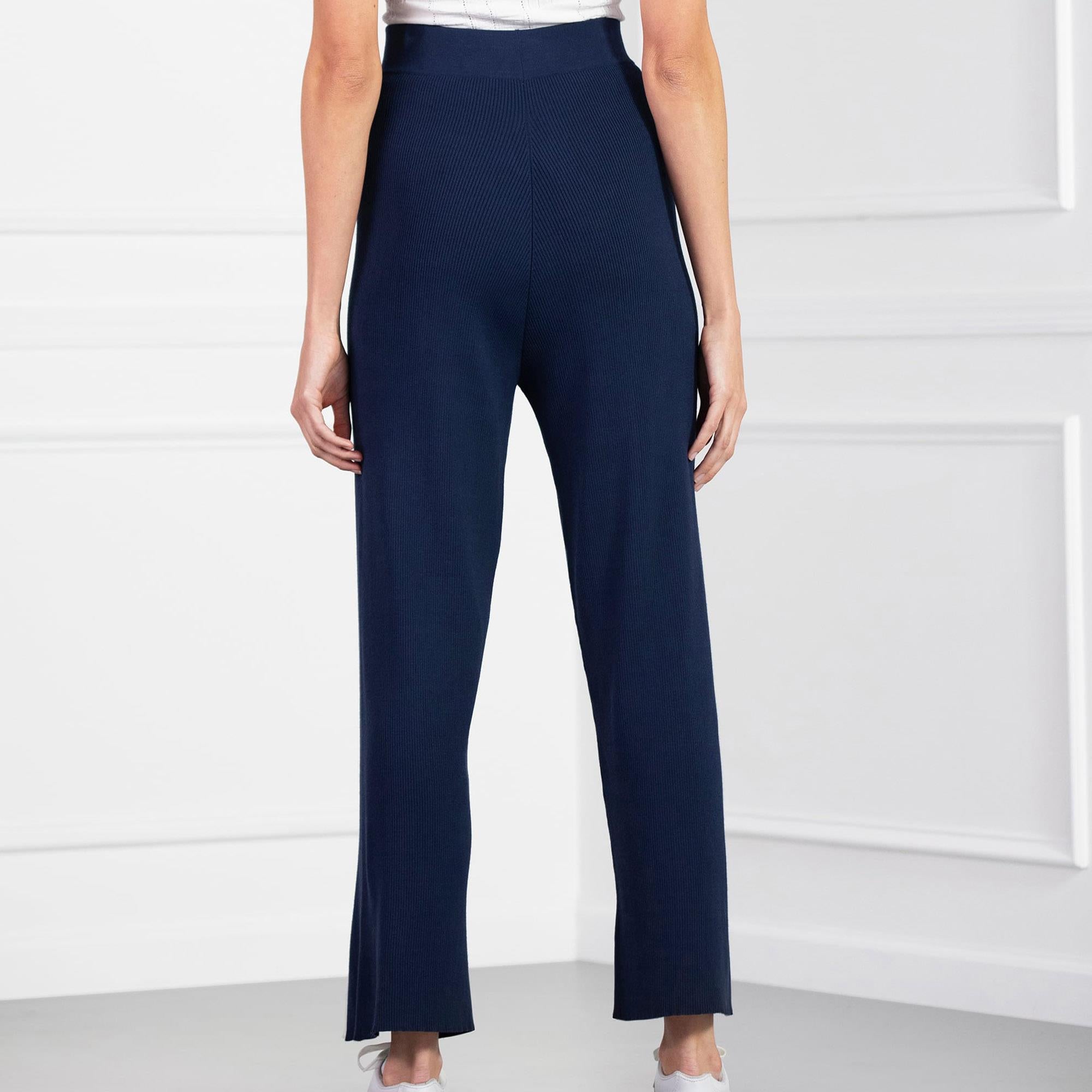 Back view of model wearing PXG Contrast Seam Ladies Golf Pants in navy